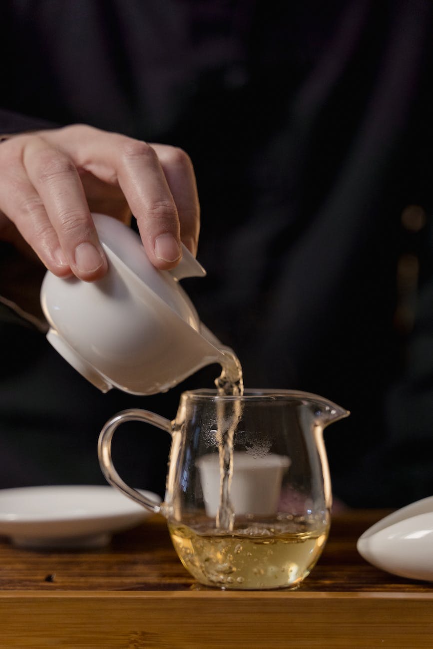 Photo by Tima Miroshnichenko on <a href="https://www.pexels.com/photo/hand-holding-ceramic-gaiwan-and-pouring-tea-in-glass-teapot-6545346/" rel="nofollow">Pexels.com</a>